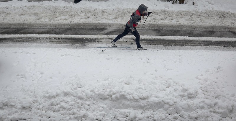 
              A cross-country skier glides on slushy snow on Brooklyn's Livingston Street, Tuesday March 14, 2017, in New York.  (AP Photo/Bebeto Matthews)
            