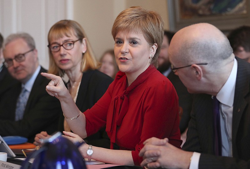 
              Scottish First Minister Nicola Sturgeon, center, gestures as she sits with Lord Advocate James Wolffe, left, Permanent Secretary Leslie Evans and Deputy First Minister John Swinney, right, during a Scottish Government cabinet meeting in Bute House, Edinburgh, Scotland Tuesday March 14, 2017.  Sturgeon announced on Monday plans for a fresh referendum on Scottish independence before Britain finally leaves the EU. (Jane Barlow/PA via AP)
            