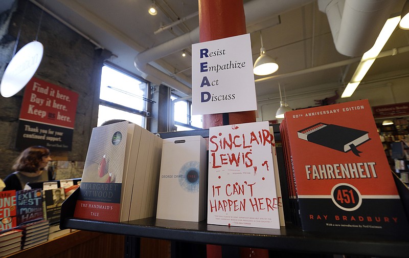 Books are displayed under a sign at the Harvard Book Store in Cambridge, Mass.