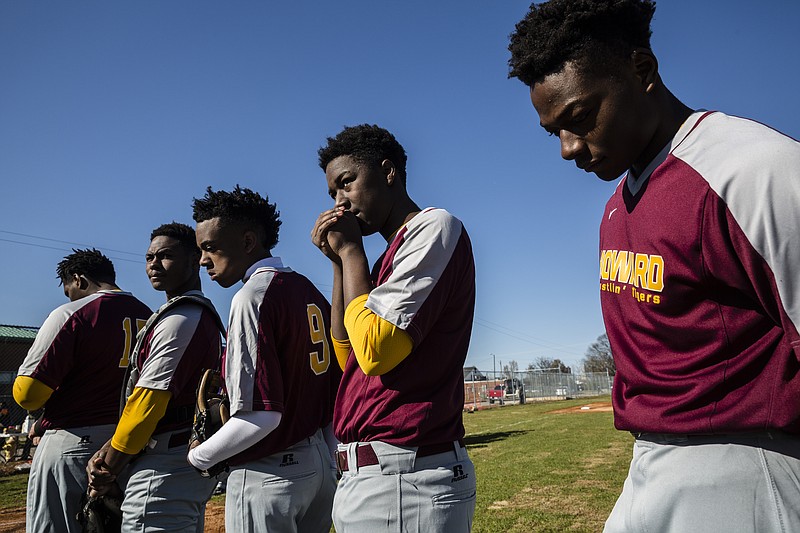 The Howard baseball team lines up for their first home baseball game in years at Howard High School on Wednesday, March 15, 2017, in Chattanooga, Tenn. The community rallied to donate materials, and the team and volunteers worked to restore the field for the school's baseball program.