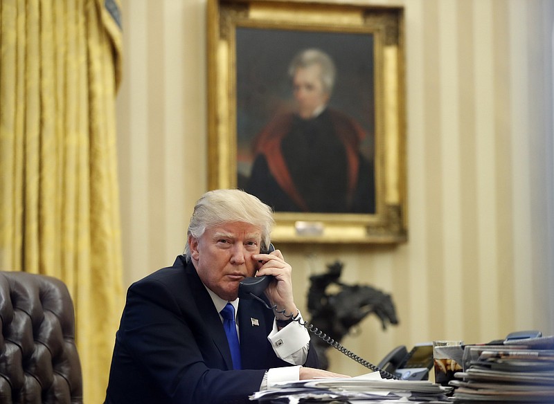 
              FILE - In this Saturday, Jan. 28, 2017 file photo, President Donald Trump speaks on the telephone with Australian Prime Minister Malcolm Turnbull in the Oval Office of the White House in Washington. In the background is a portrait of former President Andrew Jackson which Trump had installed in the first few days of his administration. Jon Meacham, who wrote a 2008 biography of Jackson titled "American Lion,” said Trump has echoed Jackson's outsider message to rural America by pledging to be a voice for "forgotten men and women." But he says it's "not the cleanest analogy." (AP Photo/Alex Brandon, File)
            