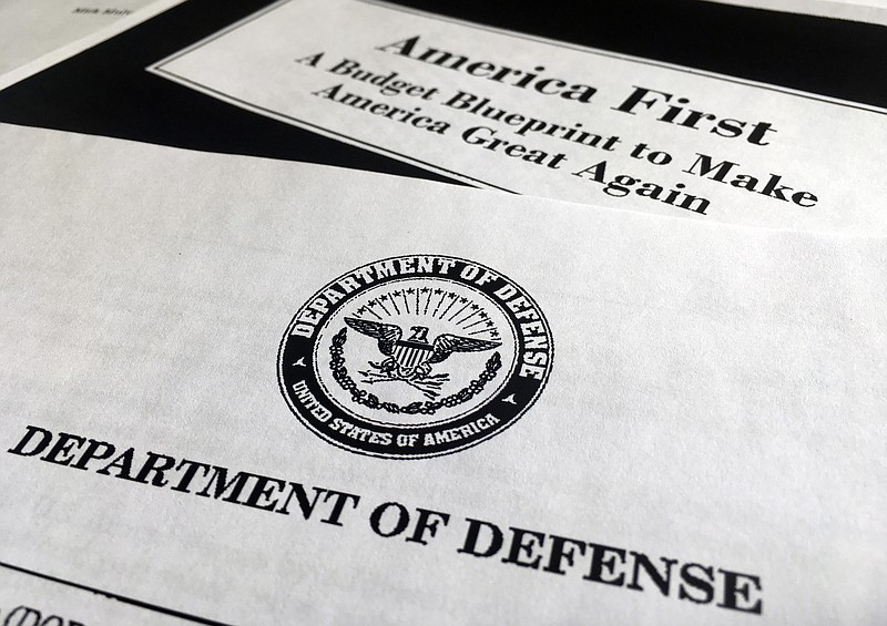 
              A portion of President Donald Trump's first proposed budget, focusing on the Department of Defense, and released by the Office of Management and Budget, is photographed in Washington, Wednesday, March 15, 2017. President Donald Trump is unveiling a $1.15 trillion budget, a far-reaching overhaul of federal government spending that slashes a dozen departments to finance a significant increase in the military and make a down payment on a U.S.-Mexico border wall. (AP Photo/Jon Elswick)
            