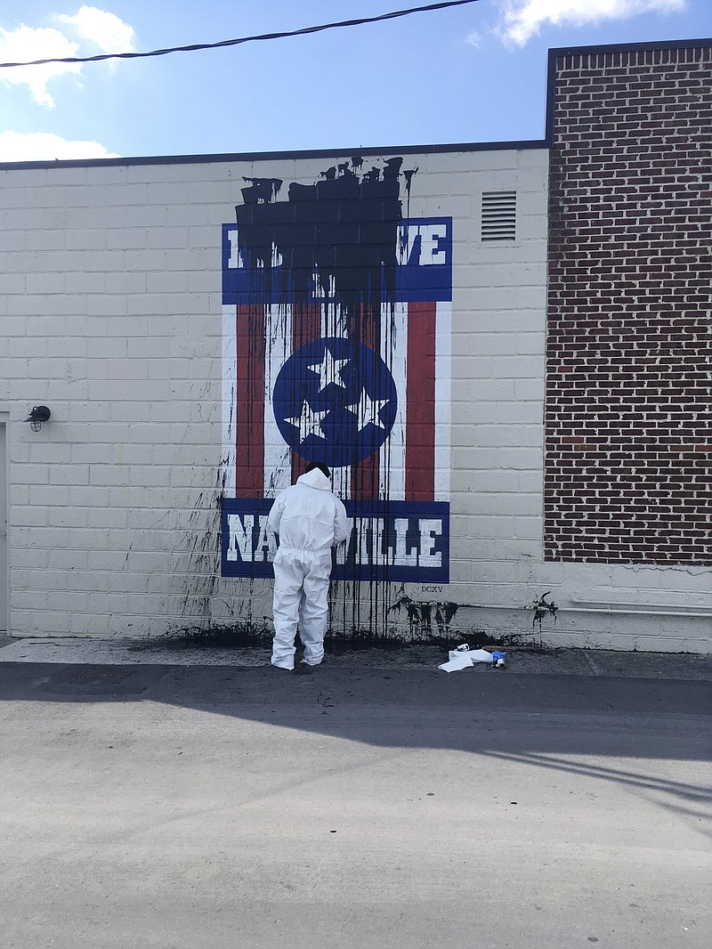 
              Nashville artist Adrien Saporiti's 12South mural, "I Believe in Nashville," was vandalized by black tar on the 12South Dental Studio building located at 2700 12th Ave. S. in Nashville, Tenn. Wednesday, March 15, 2017. Saporiti painted the mural five years ago to showcase his love of the city. (Danielle Lee /The Tennessean via AP)
            