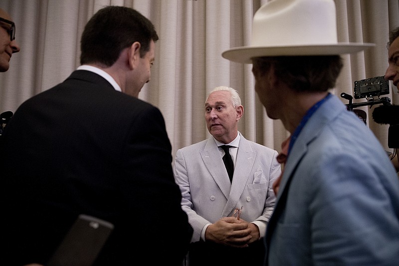 
              In this photo taken July 16, 2016, Roger Stone, an adviser to Donald Trump, center, speaks to reporters in New York. Stone says he believes his contacts with a Russian-linked hacker who took credit for breaching the Democratic National Committee were obtained through a FISA warrant, which allows the government to collect the communications of individuals suspected of being agents of a foreign power. (AP Photo/Mary Altaffer)
            