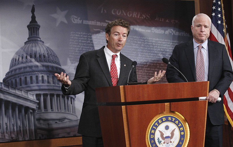 
              FILE - In this Oct. 13, 2011 file photo, Sen. Rand Paul, R-Ky., left, accompanied by Sen. John McCain, R-Ariz., gestures during a news conference on Capitol Hill in Washington. Paul has called fellow Republican McCain “a little bit unhinged” after McCain said “the senator from Kentucky is now working for Vladimir Putin.” (AP Photo/Manuel Balce Ceneta, File)
            