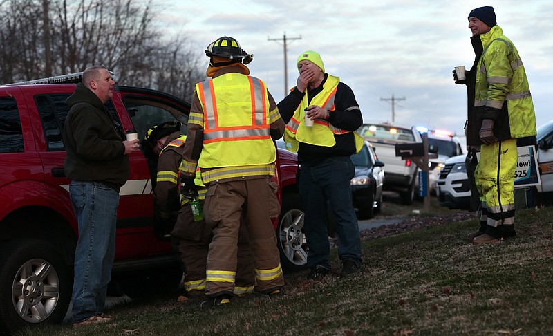 
              Firefighters and other emergency workers at the scene near Silver Lake, where a submerged SUV was found with a baby inside in Highland, Ill., on Thursday, March 16, 2017. The infant is being treated at a St. Louis hospital after the car the child was in rolled into the lake. (Robert Cohen/St. Louis Post-Dispatch via AP)
            