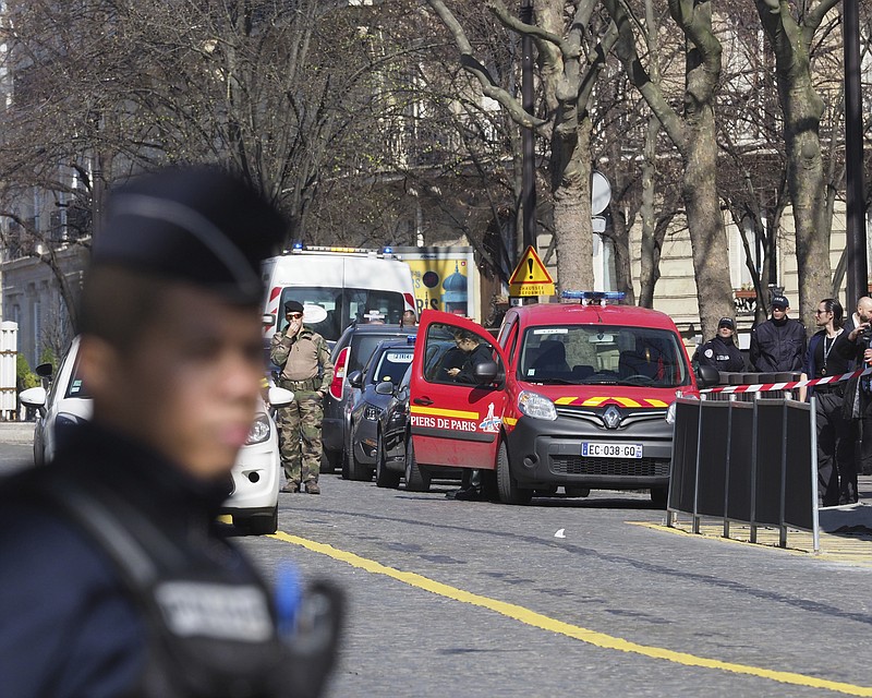 
              French police officers take position after letter bomb exploded at the French office of the International Monetary Fund, lightly injuring one person, Thursday, March 16, 2017. A police official said no other damage was been reported in the incident. (AP Photo/Thibault Camus)
            