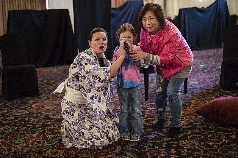 Shannon Kessler Dooley, left, plays Madame Butterfly, Willa Grace Hansard, center, plays her son Sorrow, and Mika Shigematsu plays Suzuki during a rehearsal in the Read House's Terrace Ballroom for the Chattanooga Symphony and Opera's production of Madame Butterfly on Wednesday, March 15, 2017, in Chattanooga, Tenn.