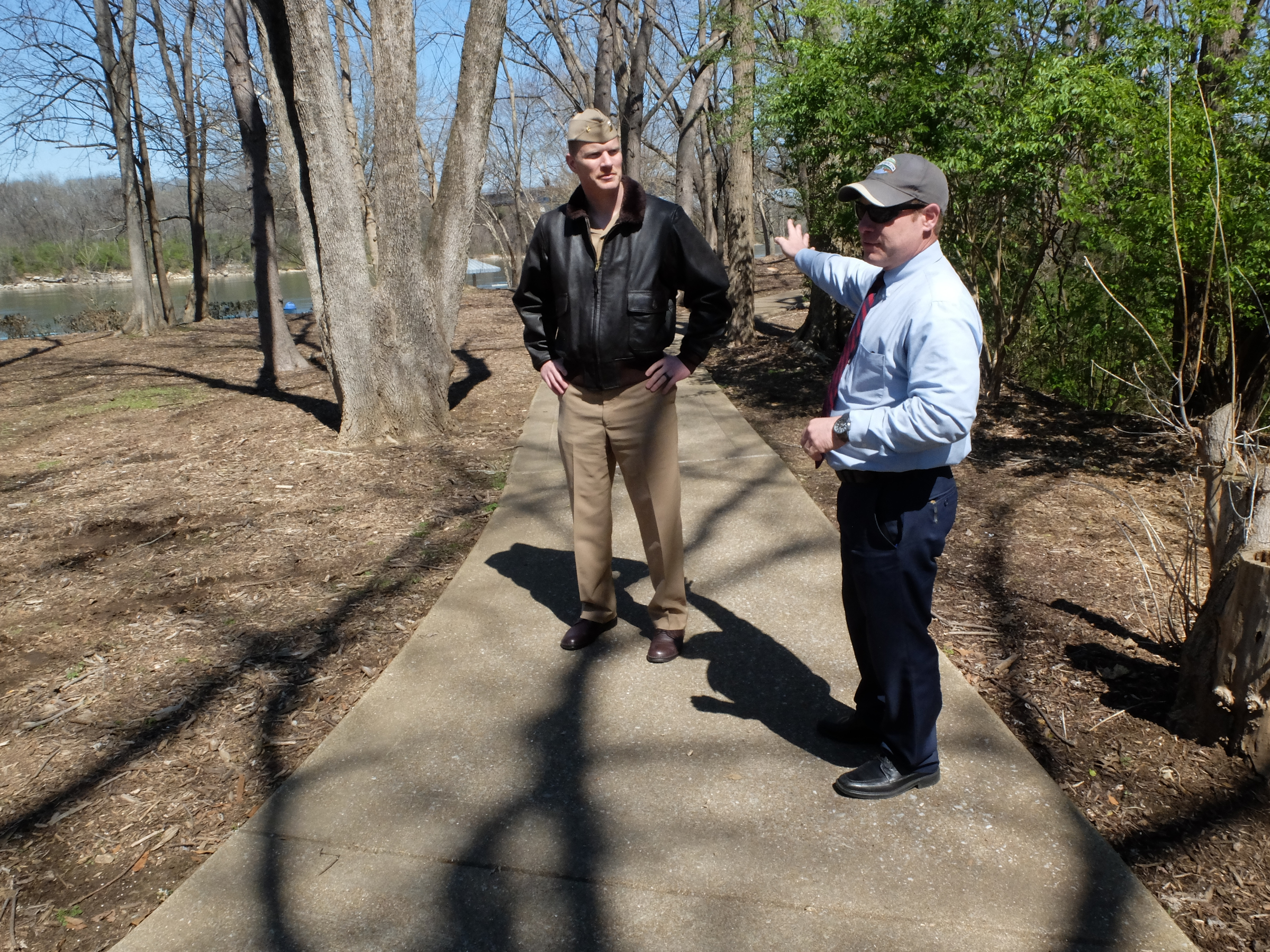 Lt. Cmdr Tim White, left, and Hamilton County Parks and Recreation Director Tom Lamb survey the possible location for a permanent July 16 memorial at the Tennessee Riverpark.