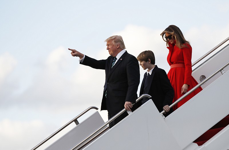 
              President Donald Trump with his wife first lady Melania Trump and their son Barron Trump, points to the applauding crown as they disembark from Air Force One upon arrival at Palm Beach International Airport in West Palm Beach, Fla., , Friday, March 17, 2017. (AP Photo/Manuel Balce Ceneta)
            