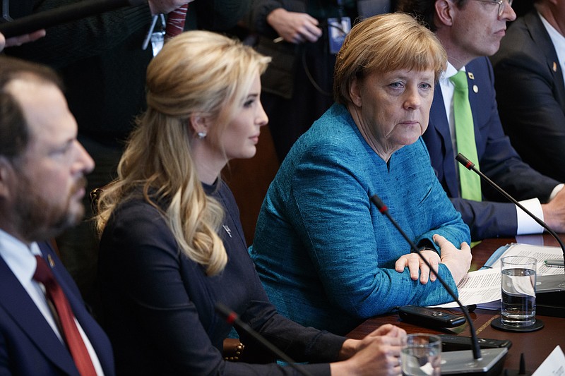 
              German Chancellor Angela Merkel sits next to Ivanka Trump during a roundtable discussion on vocational training with German and American business leaders, Friday, March 17, 2017, at the White House in Washington. (AP Photo/Evan Vucci)
            