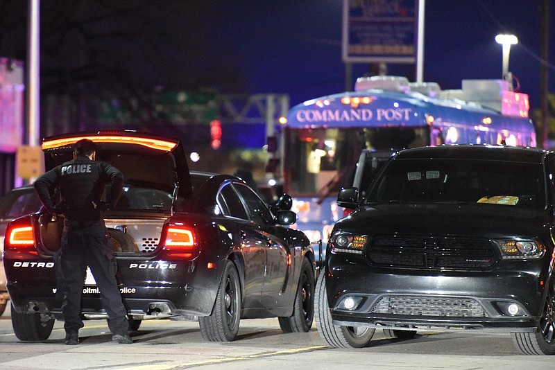 
              Law enforcement agents search the area where two police officers were shot, Wednesday, March 15, 2017 in Detroit.  A 60-year-old man suspected in the shooting of the two police officers has been arrested and the officers are in stable condition, Police Chief James Craig said Thursday.  (Tanya Moutzalias/MLive Detroit via AP)
            