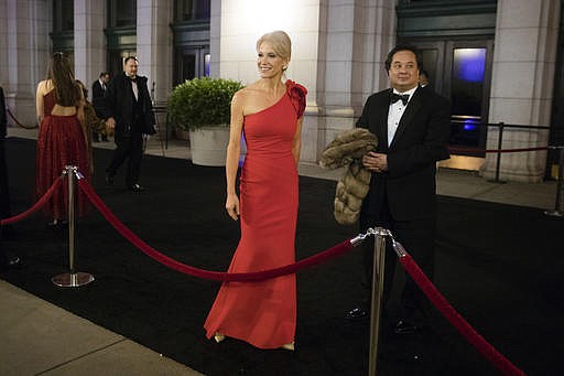 
              FILE - In this Thursday, Jan. 19, 2017 file photo, President-elect Donald Trump adviser Kellyanne Conway, center, accompanied by her husband, George, speaks with members of the media as they arrive for a dinner at Union Station in Washington, the day before Trump's inauguration. Trump has chosen George Conway to head the civil division of the Justice Department. The Wall Street Journal reports that he was chosen to head the office that has responsibility for defending the administration's proposed travel ban and defending lawsuits filed against the administration. The White House and the Justice Department would not confirm the pick Saturday, March 18, 2017. George Conway declined to comment. (AP Photo/Matt Rourke)
            