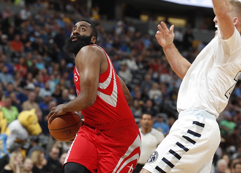 
              Houston Rockets guard James Harden, left, drives to the basket as Denver Nuggets center Mason Plumlee defends in the first half of an NBA basketball game Saturday, March 18, 2017, in Denver. (AP Photo/David Zalubowski)
            