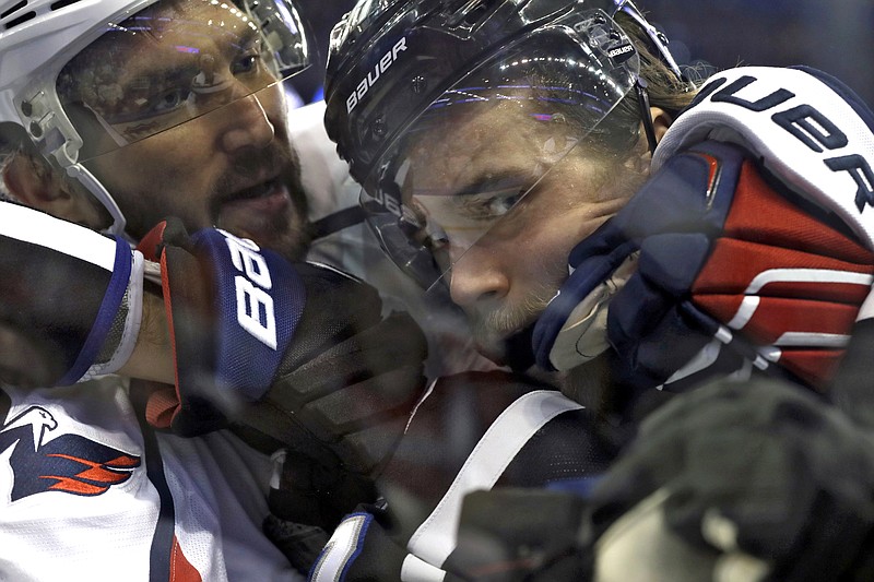 
              Washington Capitals left wing Alex Ovechkin, left, grabs Tampa Bay Lightning defenseman Victor Hedman as they scuffle in the corner during the first period of an NHL hockey game Saturday, March 18, 2017, in Tampa, Fla. (AP Photo/Chris O'Meara)
            
