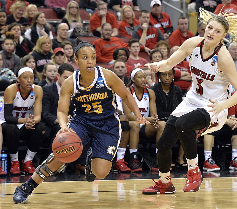 UTC's Chelsey Shumpert dribbles past Louisville's Sam Fuehring during their NCAA tournament first-round game Saturday. The Mocs lost 82-62, ending their season with a 21-11 record.