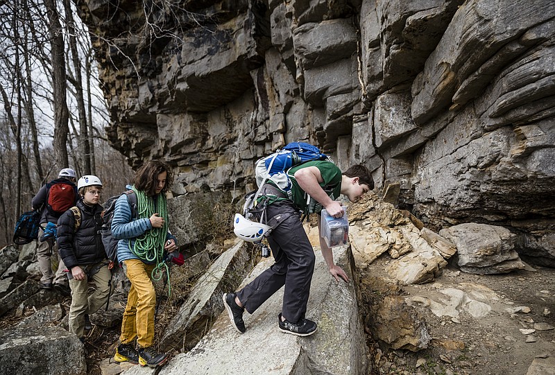 Climbers Holden Brock, Sam Briley, and Spencer Chinery, from right, climb over boulders to their next route on Denny West at the newly dedicated Denny Cove addition to South Cumberland State Park on Friday, March 17, 2017, near Sequatchie, Tenn. The 685-acre addition is home to more than 150 rock climbing routes.