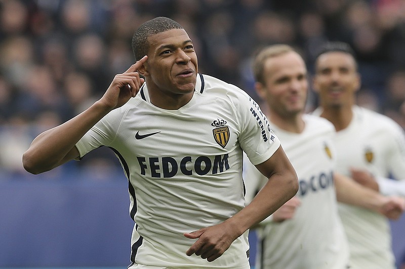 
              Monaco's Kylian Mbappe celebrates with teammates after he scored the first goal during their French League One soccer match against Caen, in Caen, north western France, Sunday, March 19, 2017. (AP Photo/David Vincent)
            