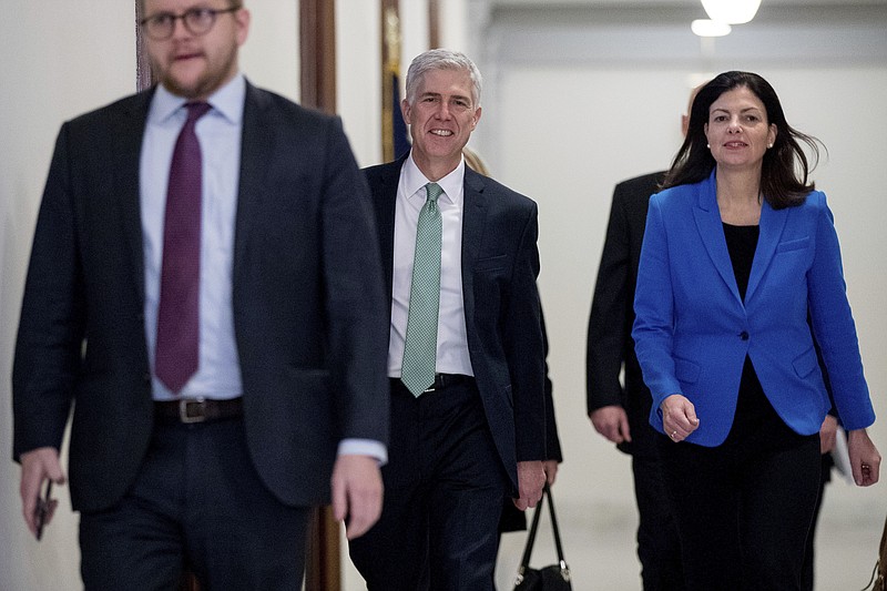 
              FILE - In this Feb. 14, 2017 file photo, Supreme Court Justice nominee Neil Gorsuch, center, accompanied by former New Hampshire Sen. Kelly Ayotte, right, arrives for a meeting on Capitol Hill in Washington, Tuesday, Feb. 14, 2017. Thirteen months after the death of Justice Antonin Scalia, the Senate is finally holding confirmation hearings to fill the vacancy, considering President Donald Trump’s choice of Gorsuch for the high court. Republicans refused even to grant a hearing to former President Barack Obama’s choice, but now the Senate will exercise its “advice and consent” role, a politically fraught decision with liberals pressuring Democrats to reject Gorsuch. A look at the process. (AP Photo/Andrew Harnik, File)
            
