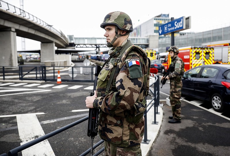 Soldiers patrol at Orly airport, south of Paris, Saturday, March, 18, 2017. Soldiers at Paris' busy Orly Aiport shot and killed a man who wrestled one of their colleagues to the ground and tried to steal her rifle Saturday, officials said. (AP Photo/Kamil Zihnioglu)

