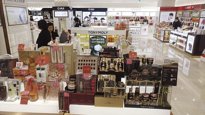 
              In this March 15, 2017 photo, employees wait for customers at Lotte Duty Free in Jeju Island, South Korea. The once-cordial ties between South Korea and its biggest trading partner have soured as China targets businesses, sports teams and culture to protest deployment of an advanced U.S. anti-missile system in South Korea. (Jo Jong-ho/Yonhap via AP)
            