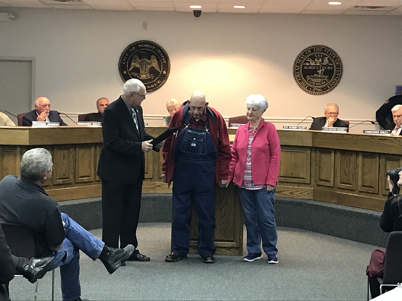 Soddy-Daisy Mayor Robert Cothran presents Billy Jack "Punk" Heard with a proclamation at the March 2 City Commission meeting. From left are Cothran, Heard and his wife of 51 years, Beverly Mills.