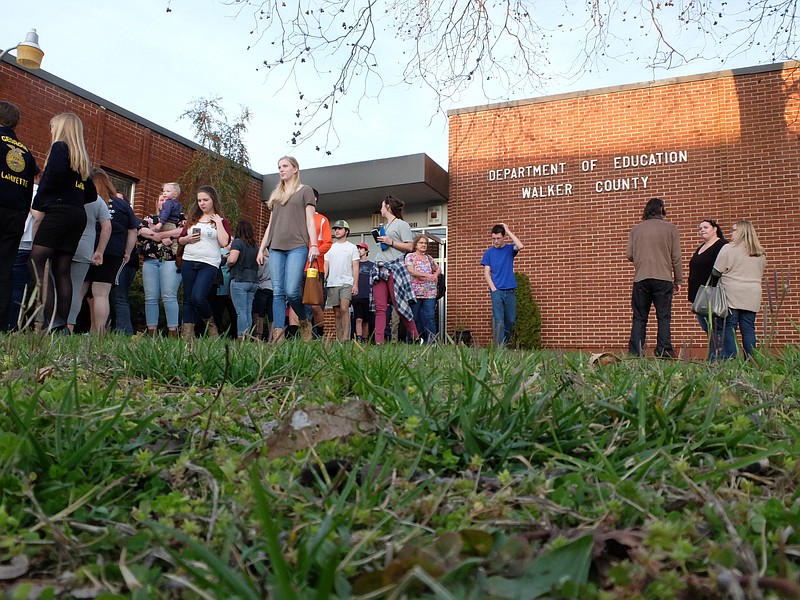 Students, parents and concerned Walker County residents exit the school board in LaFayette Monday night following Superintendent Damon Raines' statement concerning Mike Culberson, principal of LaFayette High School. "He will return to work tomorrow," Raines said.