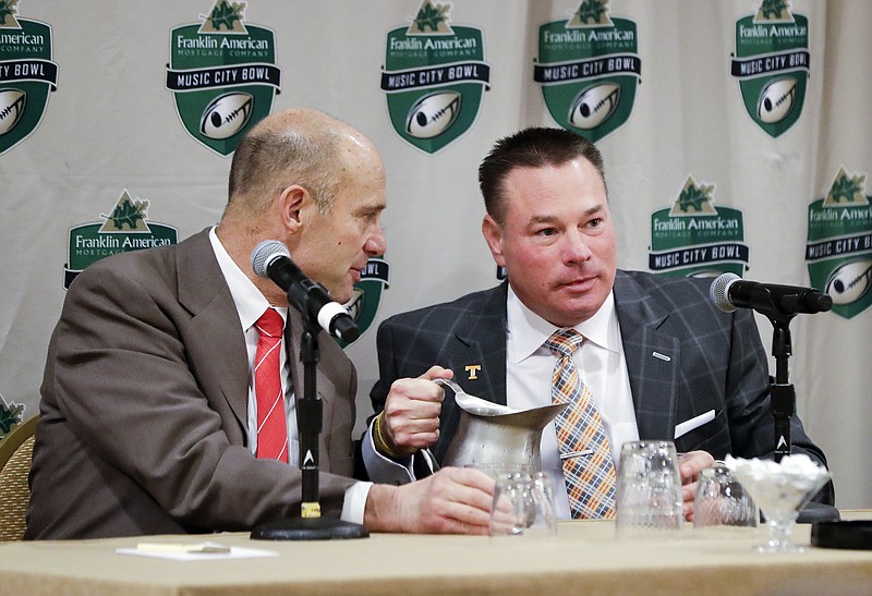 Nebraska head coach Mike Riley, left, and Tennessee head coach Butch Jones talk during a news conference Thursday, Dec. 29, 2016, in Nashville, Tenn. Nebraska and Tennessee are scheduled to play in the NCAA college football Music City Bowl Friday. (AP Photo/Mark Humphrey)