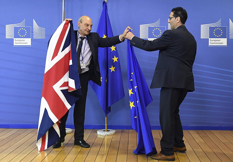 
              FILE - In this June 28, 2016 file photo, members of protocol adjust the British and EU flags at EU headquarters in Brussels. On Monday, March 20, 2017 the European Commission said it has been informed in advance of Britain's plans to trigger its exit from the EU on March 29 and stands ready to help launch the negotiations. (AP Photo/Geert Vanden Wijngaert, File)
            