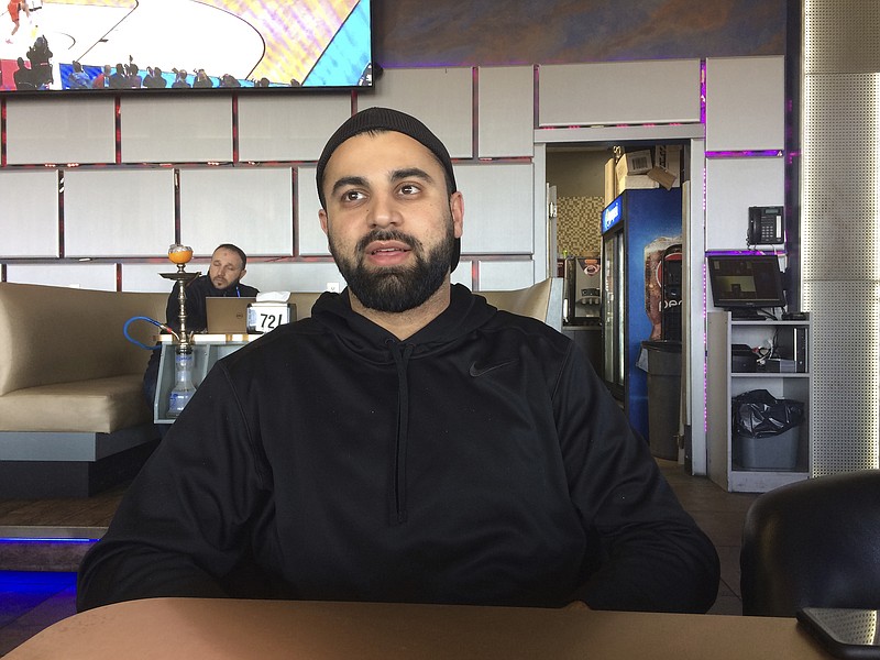 
              In this photo taken March 16, 2017, Hussein Dabajeh, 30, a lifelong Dearborn, Mich. resident who owns a hookah shop and lounge, said his ancestors first came to the U.S. from what’s now Lebanon in 1911. Still, he usually looks for the “other” box when offered the option on official forms and fully supports the idea of a new category for those who trace their roots to the Middle East. (AP Photo/Jeff Karoub)
            