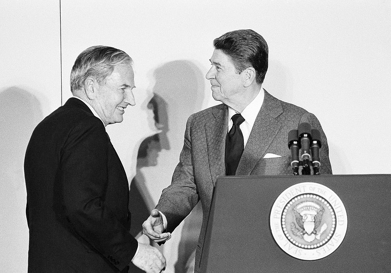 
              FILE - In this May 8, 1984 file photo, David Rockefeller, left, chairman of the Council Americas, shakes hands with President Ronald Reagan at the State Department in Washington. David Rockefeller, the billionaire philanthropist who was the last of his generation in the famously philanthropic Rockefeller family died, Monday, March 20, 2017, according to a family spokesman. (AP Photo/Ira Schwarz, File)
            