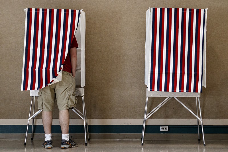 Micah Holloway casts his ballot during voting on liquor sales on Tuesday, March 21, 2017, in Rossville, Ga.