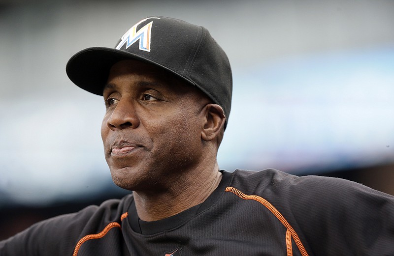 
              FILE - In this June 28, 2016, file photo, Miami Marlins hitting coach Barry Bonds looks from the dugout during the first inning of a baseball game against the Detroit Tigers in Detroit. Bonds has joined the San Francisco Giants front office as a special adviser, the team announced Tuesday, March 21, 2017. Bonds, who hit 762 career home runs, was fired last fall as the hitting coach for the Marlins after one season. (AP Photo/Carlos Osorio, File)
            