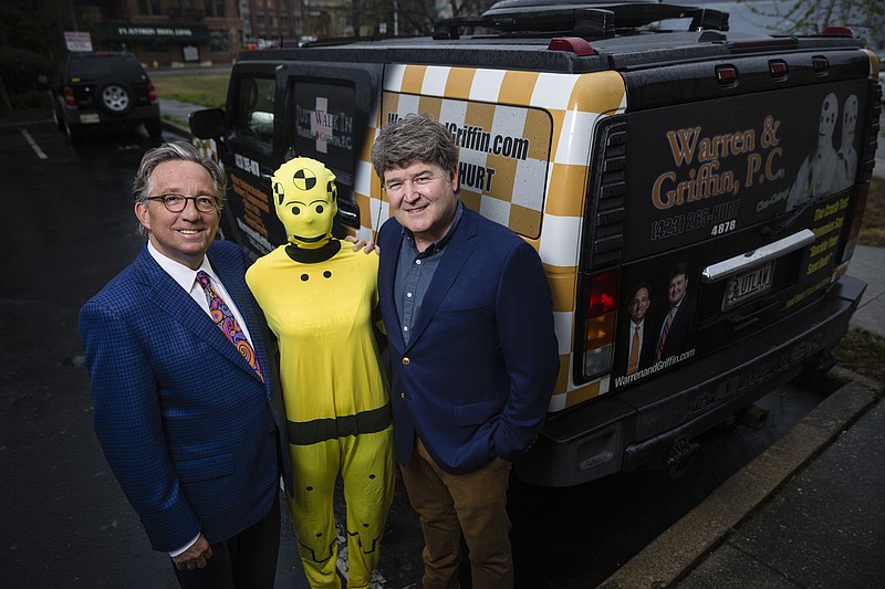 C. Mark Warren, left, and John Mark Griffin, with the local law firm Warren and Griffin, P.C., are photographed outside their offices in the Dome Building with a costumed crash test dummy which they use for their campaign against texting and driving  on Tuesday, March 7, 2017, in Chattanooga, Tenn.
