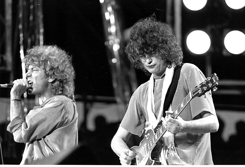 Lead singer Robert Plant, left, and guitarist Jimmy Page, right, of the British rock band Led Zeppelin perform at the Live Aid concert at Philadelphia's J.F.K. Stadium, on July 13, 1985.