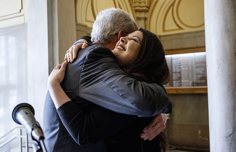 Lindsey Brown, a legal aid client, right, hugs Judge Neil Thomas after speaking about how legal aid helped her at a news conference held at the Hamilton County Courthouse to launch #Help4TNDay on Tuesday, March 21, 2017, in Chattanooga, Tenn. The day is part of the Tennessee Supreme Court's Access to Justice Initiative to help Tennesseans access legal counsel.