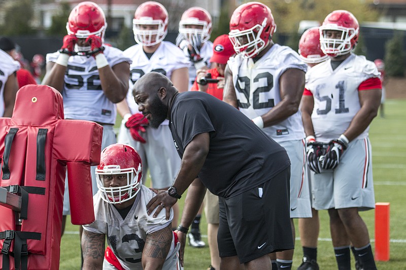 New Georgia defensive line coach Tray Scott works with junior defensive end Jonathan Ledbetter during Tuesday's start to spring practice in Athens.