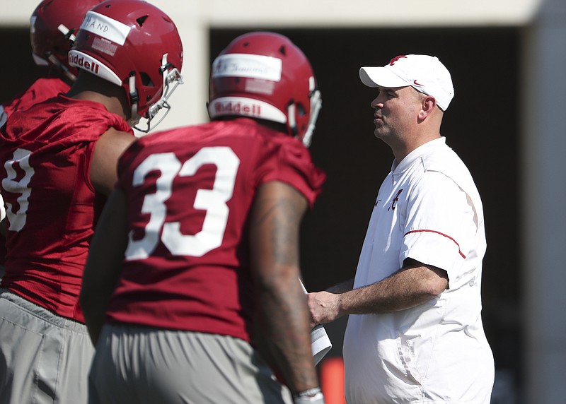 Alabama defensive lineman Da'Shawn Hand and linebacker Anfernee Jennings listen to defensive coordinator Jeremy Pruitt during Tuesday's opening spring workout in Tuscaloosa.