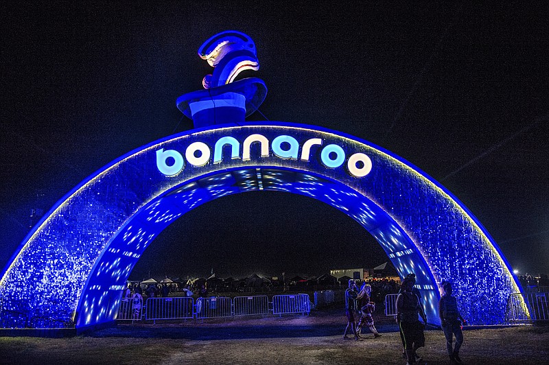 
              FILE - In this June 10, 2016 file photo, a lighted archway leading onto the farm appears at the Bonnaroo Music and Arts Festival in Manchester, Tenn. Music fans will have more options to dance the night away at the Bonnaroo Music and Arts Festival, which is unveiling an all-night stage focusing on dance, electronic and hip hop artists. The Other stage will run all night at this year’s festival, which is scheduled for June 8-11 in Manchester, Tennessee. The lineup includes Marshmello, Big Gigantic, Yellow Claw, D.R.A.M., Motama, Louis the Child, Borgore and more. (Photo by Amy Harris/Invision/AP, File)
            