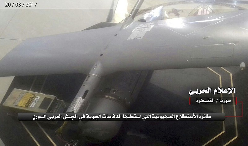 
              In this Monday, March 20, 2017 photo provided by the government-controlled Syrian Central Military Media, shows what it says is an Israeli military drone that was shot down by the Syrian military on the outskirts of Quneitra, Syria. The Israeli military has confirmed that a drone crashed in Syria earlier this week in unclear circumstances. In a statement, the military said the "Skylark" went down on Sunday and that the incident was being investigated. Arabic reads, "The Zionist drone that was shot down by the Syrian Arab Army air defenses. Central Military Media, Quneitra, Syria." (Syrian Central Military Media, via AP)
            