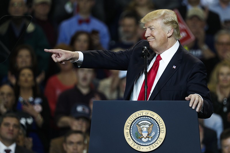 
              President Donald Trump points as he speaks during a rally at the Kentucky Exposition Center, Monday, March 20, 2017, in Louisville, Ky. (AP Photo/John Minchillo)
            