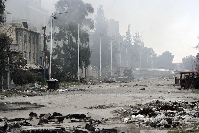 
              In this photo released by the Syrian official news agency SANA, damaged and blocked street where clashes erupted between the Syrian government forces and rebels, near the Abbassiyin square, east Damascus, Syria, Monday March 20, 2017. Syrian government forces on Monday regained control of parts of Damascus that were attacked and captured by rebels and militants the previous day, with the two-day fighting leaving dozens dead on both sides, the military and an activist group said. (SANA via AP)
            