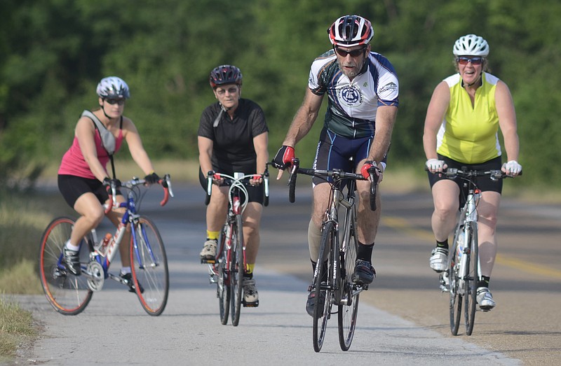 Chattanooga Bicycle Club member John Meek, second from right, leads a beginners' ride with Stephanie Evans, Donna Bhatnagar and Shannon Mobley, from left. The club stages a small weekly group ride for people who are new to cycling or are returning to the sport.