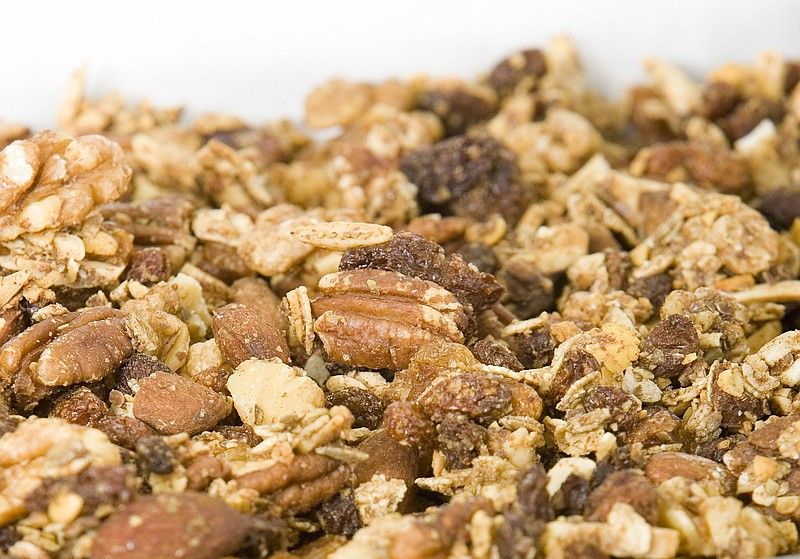 Close-up of two baking trays of muesli piled up.