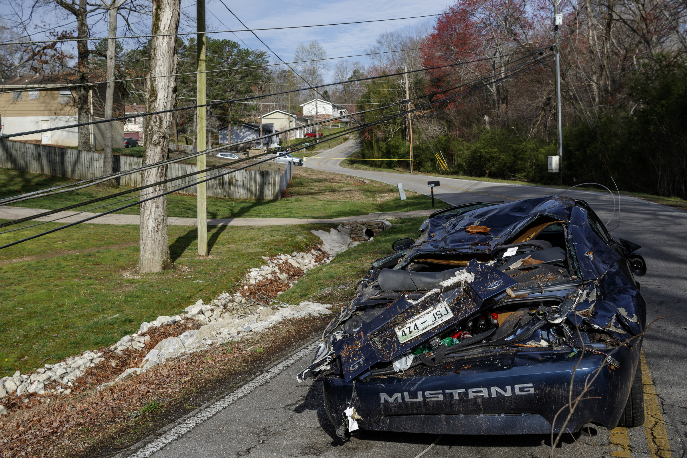 A vehicle hit by a falling tree while traveling in the 1400 block of Bowman Road is seen on Wednesday, March 22, 2017, in Hixson, Tenn., after Tuesday evening storms caused isolated damage throughout the region.