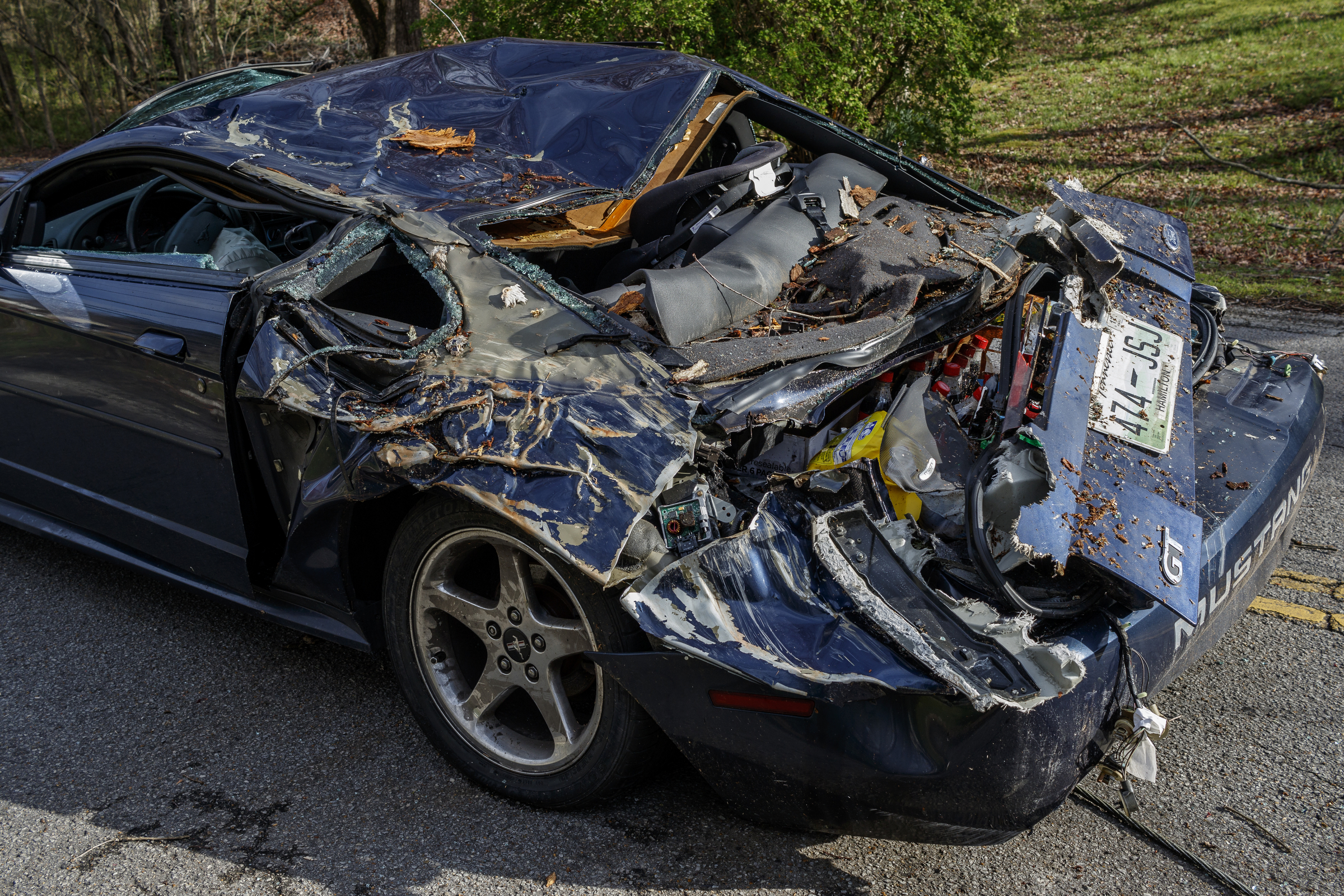 A vehicle hit by a falling tree while traveling in the 1400 block of Bowman Road is seen on Wednesday, March 22, 2017, in Hixson, Tenn., after Tuesday evening storms caused isolated damage throughout the region.