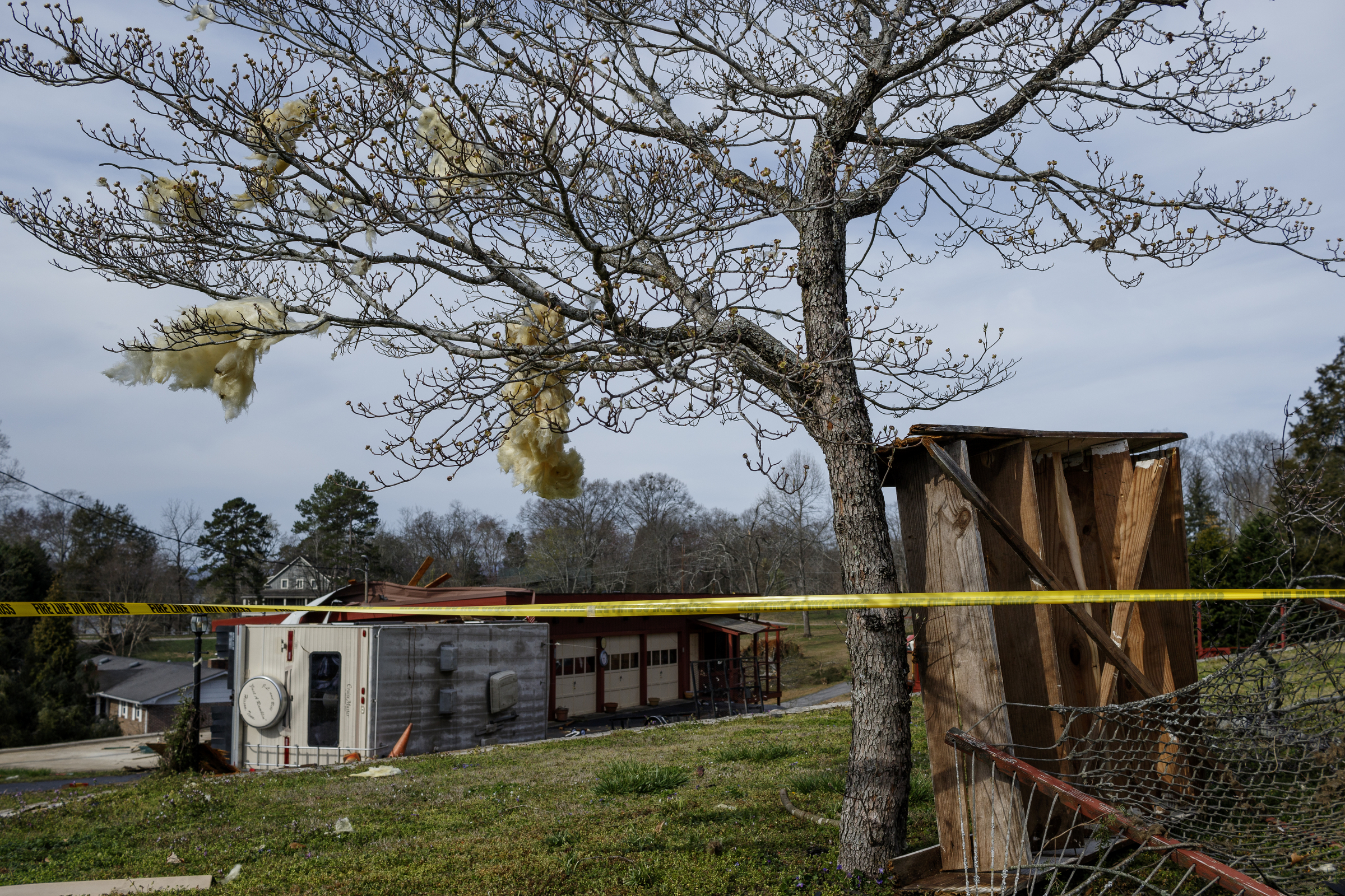 Insulation is stuck in a tree near a flipped-over RV on Berkeley Lane on Wednesday, March 22, 2017, in Hixson, Tenn., after Tuesday evening storms caused isolated damage throughout the region.