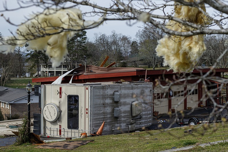 An RV is topped over next to a damaged garage on Berkeley Lane on Wednesday, March 22, 2017, in Hixson, Tenn., after Tuesday evening storms caused isolated damage throughout the region.