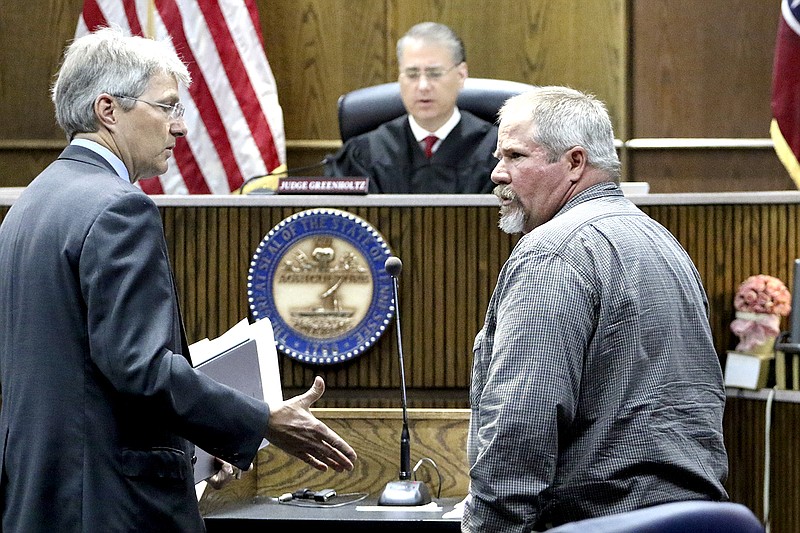 Staff Photo by Dan Henry / Defense attorney Lee Davis, left, moves to shake Samuel Edward Reeves' hand before Reeves is taken into custody. Reeves pleaded guilty to voluntary manslaughter before Judge Tom Greenholtz in the 28-year-old cold case killing of James "Richard" Layne on Feb. 20, 1989.