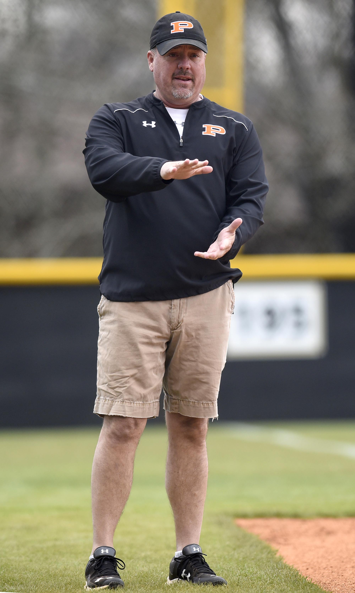 Staff Photo by Robin Rudd South Pittsburg coach Vic Grider, shown giving instructions to a batter, said he has relished the opportunity coaching his daughter, Victoria, who is now a senior for the Lady Pirates.
